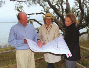 Client, architect and builder review floor plans for a proposed home